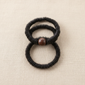 Mekong Stack — three handcrafted coconut shell bracelets with carved wood focal bead center