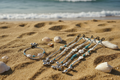 Lifestyle photo of double strand turquoise sea turtle beaded bracelet and anklet on a sandy beach with ocean waves in the background