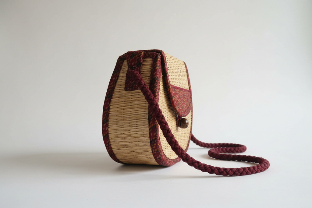 Chantao Burgundy Rattan Saddle Bag — side view with burgundy woven rope strap
