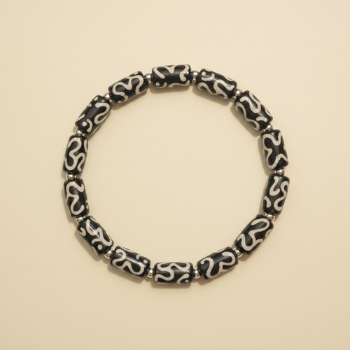 Black Totem Bracelet flat lay on cream background