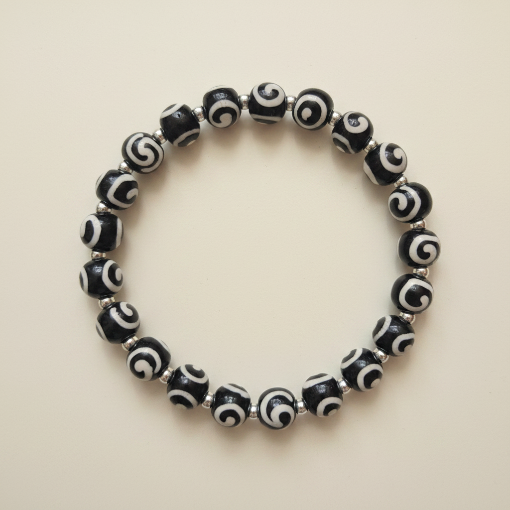Midnight Swirl Bracelet flat lay on cream background